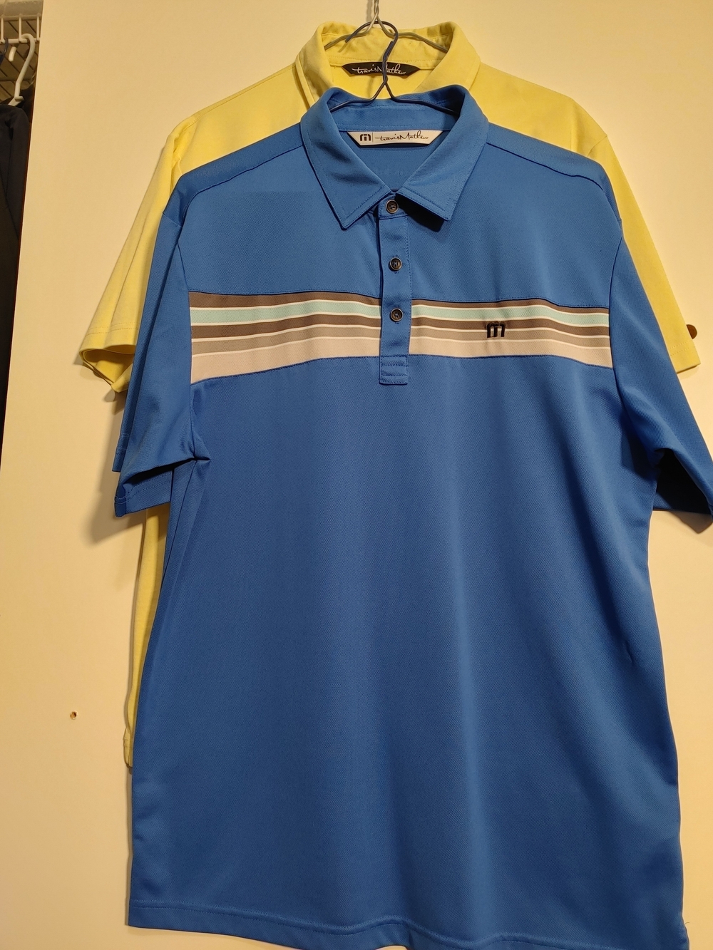 Travis Mathew Men's Sky Blue and Yellow Polo with Multi-Striped Chest Combo.